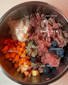 the ingredients in a mixing bowl are mixed with meat, potatoes, carrots and blueberries