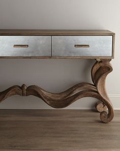 a wooden table with two drawers sitting on it's side, in front of a white wall