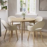 a dining room table with four chairs around it