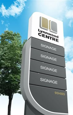 the sign for lynnwood centre in front of a tree and blue sky with clouds