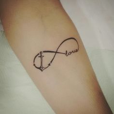 a tattoo with an anchor and the word love written in cursive writing on it