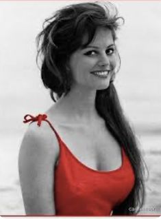 a black and white photo of a woman in a red top