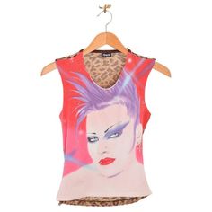 DOLCE & GABBANA PUNK FACE VEST 2000's 2000's Dolce & Gabbana vest top with garish punk face on the front, leopard print mesh reverse & safety pin side detail. Features; Stretchy cotton fit Sleeveless Safety pin side detail Front; 45% Cotton / 39% Nylon / 9% Spandex / 7% Lyrca Back; 63% Cupro / 37% Polyester Sizing; Pit to Pit; 16'' - 18'' Nape to Hem; 21'' Condition; Condition 10/10 Fitted Sleeveless Y2k T-shirt, Edgy Streetwear Vest Top, Punk Streetwear Vest Top, Y2k Pink Graphic Print Tank Top, Fitted Graphic Print Tank Top For Alternative Fashion, Fitted Punk Tank Top With Graphic Print, Alternative Fashion Graphic Print Tank Top, Y2k Graphic Print Vest For Spring, Spring Y2k Vest With Graphic Print