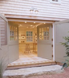 an open garage door showing the dining area