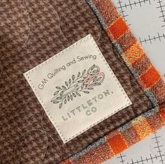 a close up of a piece of fabric with a label on it that says, can quilt and sewing