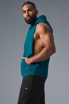 Stay cozy without sacrificing style in the Renown Sleeveless Hoodie. It has deep armholes, a kangaroo pocket, and a laid-back cut. And wait till you feel the Alo signature Renown fabric—it's smooth on the outside, a little fleecy on the side, and heavyweight for a just-right drape. Add shorts and you’re covered from the gym to the street. Sleeveless Athleisure Top With Drawstring Hood, Athleisure Hoodie With Pockets For Gym, Sportswear Tops With Pockets For Workout, Sportswear Workout Tops With Pockets, Sporty Workout Tops With Pockets, Workout Sportswear Tops With Pockets, Sleeveless Hoodie For Gym In Athleisure Style, Sleeveless Athleisure Hoodie For Workout, Alo Yoga Hooded Top With Drawstring Hood