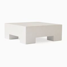 a white square table sitting on top of a white floor