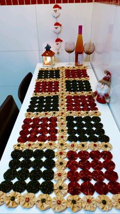 the table is decorated with red, black and gold ribboned placemats on it