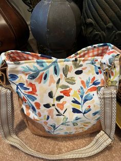 Gorgeous floral pattern bag.  Made with canvas exterior and fabric lining.  One of a kind.  Interior is orange checked canvas fabric.  Bag has two nice sized pockets on interior and one zippers pull pocket.  Four metal feet on bottom.  Magnetic snap closure on top.  Great quality, cork accents.  Can wear as a handbag or crossbody bag.  Will last for years to come.  Friends will go crazy over this handmade bag! Spring Canvas Bag With Zipper Pocket, Multicolor Fabric Bags With Zipper Closure, Multicolor Canvas Shoulder Bag With Zipper Closure, Fabric Bag With Cell Phone Pocket For Everyday Use, Fabric Bags With Cell Phone Pocket For Everyday Use, Daily Use Fabric Shoulder Bag With Zipper Pocket, Fabric Shoulder Bag With Adjustable Strap, Fabric Shoulder Bag With Zipper Pocket For Daily Use, Orange Satchel With Zipper For Everyday Use