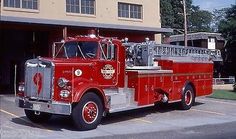 a red fire truck parked in front of a building