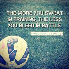 a soccer ball sitting in the grass with a quote on it that reads, the more you sweat in training, the less you bleed in battle