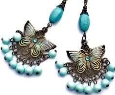 "Flirty chandelier earrings featuring filigree butterfly accents on embossed antiqued pendants that swing over dangling pale turquoise blue glass beads! Each of the butterflies are accented with painted touches of sea foam green & turquoise and little Swarovski crystal rhinestones sparkle in their centers! Each unique pendant dangles from genuine magnesite beads, too, which are thought to aid in meditation and creativity! Just dangle this unique pair from your ears to add fun, Boho style to Bohemian Butterfly Jewelry With Pierced Design, Bohemian Dangle Jewelry With Butterfly Charm, Bohemian Jewelry With Butterfly Charm Dangle, Dangle Bead Earrings, Red Beaded Earrings, Blue Choker Necklace, Butterfly Boho, Ribbon Choker Necklace, Silver Bead Earrings