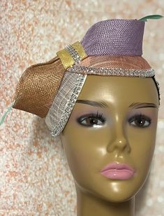 This bronze, peach, and purple pastel multicolor double disc Sinamay fascinator is trimmed withfeather stem, sinamay bows, and rhinestones. The hat pin may vary and is for decorative purposes only. Make a statement with this gorgeous piece! The hat measures approximately 9 by 4.5 inches. The hat affixes to the head by a hat elastic/string. Handmade Gifts for mom, sister, wife, or yourself. SHIPPING All items for free shipping will be shipped via USPS FIRST CLASS MAIL. Whimsical Purple Fascinator For Parties, Multicolor Carnival Headband Fascinator, Adjustable Multicolor Fascinator, Whimsical Purple Mini Hat For Party, Adjustable Orange Mini Hats For Party, Multicolor Headband Fascinator For Party, Multicolor Headband Fascinator For Weddings, Multicolor Wedding Fascinator Headband, Elegant Multicolor Carnival Headpieces