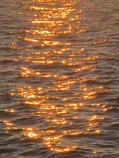 the sun shines brightly on the water as it is reflected in the ocean waves