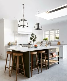 a kitchen with two stools and an island