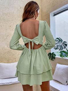 The ncocon green ruffles dress stole our hearts at first glance! Crafted from sheer woven fabric, this chic dress boasts a darted bodice and a square framed by long puff sleeves with elasticized, ruffled cuffs. Spin around to reveal an alluring back cutout (with double top button closure) that sits atop a fitted waist and an A-line mini skirt finished with a flirty ruffled hem. A hidden back zipper/clasp ensures a comfortable and secure fit. This dress is the perfect choice for an elegant and so Green Mini Dress With Ruffle Hem, Green Ruffled Mini Dress, Chic Green Mini Dress With Ruffles, Green Mini Dress With Ruffle Hem And Square Neck, Green Tiered Mini Dress For Brunch, Green Long Sleeve Dress With Ruffle Hem, Green Mini Dress With Ruffle Hem For Brunch, Chic Green Mini Dress With Ruffle Hem, Chic Green Dress With Ruffle Hem