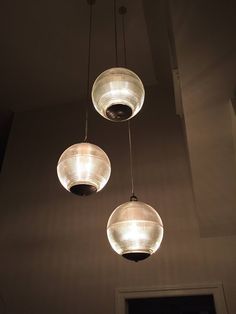 three lights hanging from the ceiling in a room