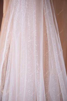 Perfect for wedding dress overlays and underlays, our premium shimmery glitter tulle fabric adds a touch of elegance to any formal gown, ensuring you shine on your special day. shown color: white sold by the yard content: polyester, PET light weight width: 150cm swatches: available Glitter Bride Dress, Elegant Shimmer Tulle Fabric For Wedding, Glitter Tulle Fabric With Sequins For Wedding, Elegant Glitter Tulle Fabric For Wedding, Wedding Tulle Sequin Fabric, Wedding Glitter Tulle Fabric, Glitter Tulle Fabric, Shimmer Wedding Dress, Handwork Design