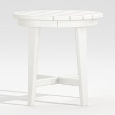 a white round table with four legs