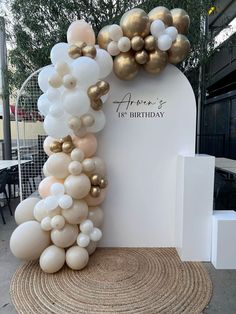 an arch made out of balloons with the words happy birthday written on it and gold foiled balloons