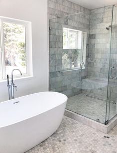 a white bath tub sitting next to a window