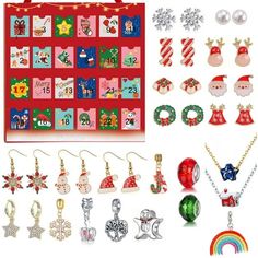 christmas themed jewelry is displayed in front of a red board with santa's and snowmen on it