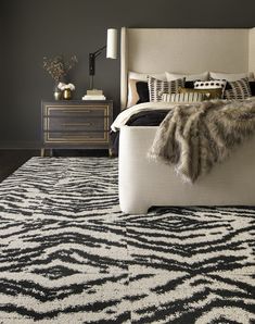 a bedroom with black and white rugs on the floor