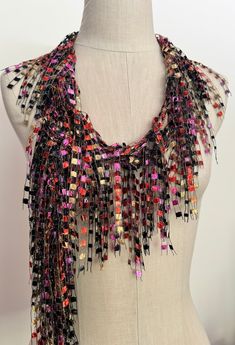 Hand knitted scarf in beautiful colors of burnt orange, satin gold, pink and raven black accented with silver metallic for the sparkle. Lot of bling with beautiful Italian ladder yarn to brighten up your outfit. Sure pop of color for any matching color outfits. Modern creative and stylish way to dress up everyday attire or add a showstopper accessory for your evening wear just by folding in half and throwing it over your shoulder and securing it with a sparkly pin. Surprise your friend or mom with something different for her special day. Great colors for fall. This is about 70"L 1"W  open traditional scarf. Hand wash in lukewarm water with mild soap, don't rub or wring, squeeze off excess water and hang to dry. Warm iron is ok if needed.  Comes with nice organza satchel for traveling or gi Handmade Black Scarf For Fall, Handmade Black Scarves For Fall, Multicolor Bohemian Scarves For Party, Multicolor Bohemian Party Scarves, Bohemian Multicolor Party Scarves, Multicolor Party Scarf One Size, Handmade Black Scarves As Gifts, Black Bohemian Scarves For Festive Occasions, Black Bohemian Scarf For Festive Occasions