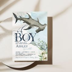 a boy shark themed baby shower is displayed on a plate with the word boy written in it