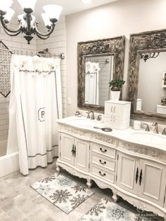 a bathroom with two sinks, mirrors and a shower curtain in it's corner