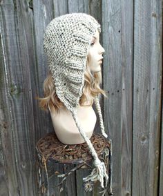 a mannequin head wearing a knitted hat on top of a wooden table