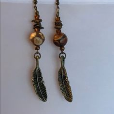 Handmade By Me, Round Sandstone Beads And Bronze Feather Earrings. 3 3/4” Long. Posts Are Lead Free Brown Adjustable Earrings With Natural Stones, Adjustable Bohemian Brown Beaded Earrings, Bohemian Brown Wire Wrapped Beaded Earrings, Brown Metal Beaded Dangle Earrings, Brown Metal Beaded Earrings With Ear Wire, Adjustable Brown Beaded Earrings With Dangling Beads, Elegant Brown Metal Beaded Earrings, Adjustable Nickel-free Bronze Beaded Earrings, Adjustable Nickel Free Bronze Beaded Earrings