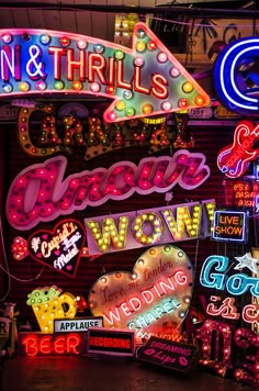 many neon signs are hanging on the wall