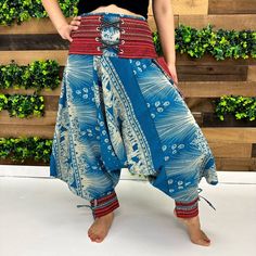 "Cotton Harem Pants with Ankle Straps, Thai Yoga Pants, Elephant Pants, Embroidered Pants,Unisex Pants, Hippie ,Boho Clothing,Low Crotch Pant Handmade Material: Organic Cotton Adjustable Waist Unisexual  One small pocket Size: One Size; Fits from US Size Small to Large Waist: Approx.28\" to 38\" Hips: Approx.  24\" to 48\" Length: Approx. 35\" Our Unisex Cotton Harem Pants provide a comfort-first design ideal for any season. Crafted from a lightweight, breathable cotton blend, these harem-style pants are perfect for yoga or casual wear. With a unisex style, adjustable ankle straps, and a relaxed fit, these pants offer the perfect combination of fashion, comfort, and versatile wearability. These Cotton Harem pants with open-side legs and ankle cuffs with adjustable straps are very comfortab Blue Baggy Embroidered Bottoms, Casual Boho Print Pants For Festivals, Bohemian Non-stretch Bottoms With Boho Print, Spring Boho Print Harem Bottoms, Casual Boho Print Festival Pants, Traditional Summer Festival Bottoms, Traditional Baggy Pants For Spring, Traditional Style Baggy Pants For Spring, Hippie Embroidered Bottoms For Summer