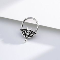 a ring with a bat hanging from it's side on a white surface,