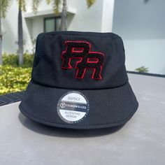 TAINOWEARS Exclusive Puerto Rico Bucket Hat, a statement piece that blends comfort with cultural pride. Crafted from 100% premium cotton, this bucket hat offers a soft, breathable fit that’s perfect for sunny days or casual gatherings. Featuring a plush Chenille patch with the bold 'PR' logo at the crown, this hat adds a touch of luxury and Puerto Rican identity to your wardrobe. Designed with versatility in mind, this one-size-fits-most bucket hat ensures a comfortable fit for a wide range of h Streetwear Bucket Hat With Embroidered Logo And Curved Brim, Streetwear Bucket Hat With Embroidered Logo, Cotton Bucket Hat With Embroidered Logo For Streetwear, Hip Hop Cotton Hat With Embroidered Logo, Adjustable Wide Brim Bucket Hat With Embroidered Logo, Black Wide Brim Hat With Embroidered Logo, Embroidered Logo Bucket Hat For Streetwear, Adjustable Bucket Hat With Embroidered Logo And Flat Brim, Black Bucket Hat With Embroidered Logo For Streetwear