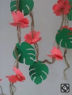 some paper flowers are hanging from a string on the wall and there is no image here to provide a caption for