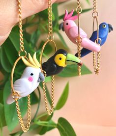 Handmade hanging bird earrings. Made from polymer clay. Lightweight. Great for summer, tropical vacations, or just because. Options include colorful parrots, cockatoos, and toucans. Perfect for bird lovers, those who love quirky eclectic finds, and fans of tropical areas. | Hanging Bird Earrings, Parrot Earrings, Toucan Jewelry, Cockatoo Earring, Tropical Bird Earrings, Summer Jewelry, Unique Earrings Parrot Earrings, Swan Jewelry, Clay Bird, Quirky Earrings, Colorful Parrots, Tropical Bird, Funky Earrings, Love Animals, Ceramics Projects