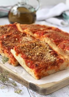 sliced pizza sitting on top of a wooden cutting board