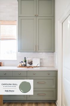 a kitchen with gray cabinets and white counter tops, painted in carolina guill's oak story