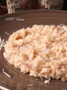 a close up of a plate of food with rice on the side and garnished with shredded parmesan cheese