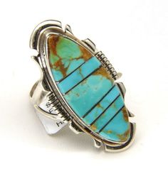 Handmade by Navajo artist Steve Francisco Turquoise Inlay Ring!-Beautiful elongated oval with inlay turquoise pieces-Turquoise is very bright blue with some green and brown matrix-Intricate silver work make this setting unique-Ring is marked "Sterling" "SF", sticker tag states artist name and ring information-Ring face measures 1.48" x .7"-Turquoise complete section measures 32mm x 12mm lens shaped with fine silver lines dividing the inlay-Depth of ring .22"-Size 9.25-Total weight 8.6g-Ring is i Artisan Turquoise Ring With Inlay, Luxury, Southwestern Style Turquoise Inlay Ring, Western Style Oval Turquoise Inlay Ring, Western Oval Turquoise Ring With Inlay, Western Style Oval Turquoise Ring With Inlay, Oval Turquoise Inlay Jewelry, Western Turquoise Ring With Inlay, Western Style Turquoise Ring With Inlay, Vintage Turquoise Jewelry