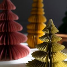 folded paper christmas trees on a table