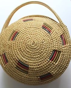 Here we have a cute Vintage Large Round Straw Raffia Tote Handbag from the 1970s.  It has two straw handles and it is made of woven raffia.  It has green, red and yellow raffia accents.  The bag measures 14 inches in diameter, 17 inches tall including the handle and 2 1/2 inches thick around the edges.  It is in fantastic shape minus some wear on the bottom.  This awesome purse would make a great addition to any outfit! Brass Spoon, Woven Raffia, Vintage Rainbow, Tote Handbag, Red And Yellow, Cute Sweaters, Decorative Wicker Basket, Tote Handbags, Straw Bag