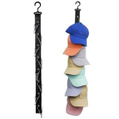 several hats hanging from hooks on a white background