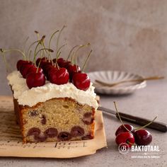 a piece of cake with cherries on top