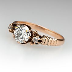 a gold ring with two diamonds on it