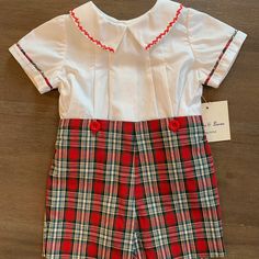 This Is A Brand New Sophie And Lucas 2 Piece Short Set. The Shorts Are A Bright Christmas Plaid And The Top Is A Short Sleeve White With Matching Plaid Trim Around The Arms. The Collar Has Beautiful Bright Red Stitching. The Top Buttons Up The Back And The Shorts Button Onto The Shirt. All Of My Items Are New From My Closed Children's Store. I Am Listing At Fair Prices So Please Do Not Send Silly Offers Red Cotton Holiday Set, Fitted Red Set For Holidays, Christmas Cotton Playtime Sets, Cotton Sets For Playtime During Holidays, Cotton Playtime Sets For Holiday, White Holiday Playtime Sets, Fitted Cotton Christmas Sets, Fitted Red Playwear Sets, White Holiday Sets