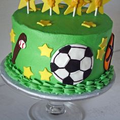 a birthday cake decorated with soccer balls and stars