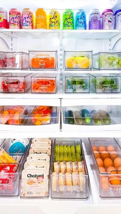 an open refrigerator filled with lots of different types of drinks and food in plastic containers